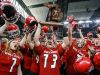 Romeo's Christopher Zanke lifts the MHSAA Football Champion trophy in the air surrounded by his teammates, after defeating Detroit Cass Tech in the Michigan High School Athletic Association football Division 1 finals at Ford Field in Detroit on Saturday, Nov. 28, 2015.