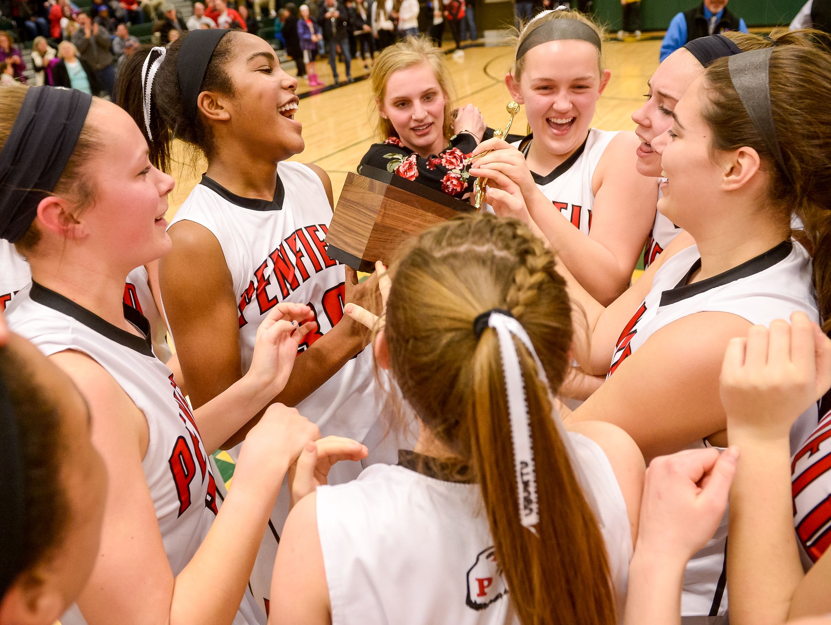 The Penfield girls basketball team celebrates after winning the Section V Class AA Championship on Feb. 27, 2016.