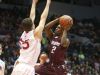 Aquinas's Earnest Edwards drives to the basket against Fairport's Cam Keeley (55). Edwards scored 23 in a 47-43 Aquinas win in the Class AA final.