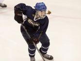 Brighton High School sophomore Rene Gangarosa carries the puck up the ice in a game.