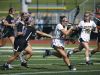Victor's Bridget Flynn runs with the ball as Hamburg's Maddy Reardon tries blocking her with the stick in the first half at Pittsford Sutherland High School.