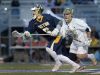 Victor's T.D. Ierlan, left, wins a faceoff from Corning's Jake McNaney during the NYSPHSAA Class A Western Semifinal.