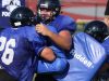 Mike Mattison breaks through a block by Jagger Kachmaryk and Anthony Polizzi.