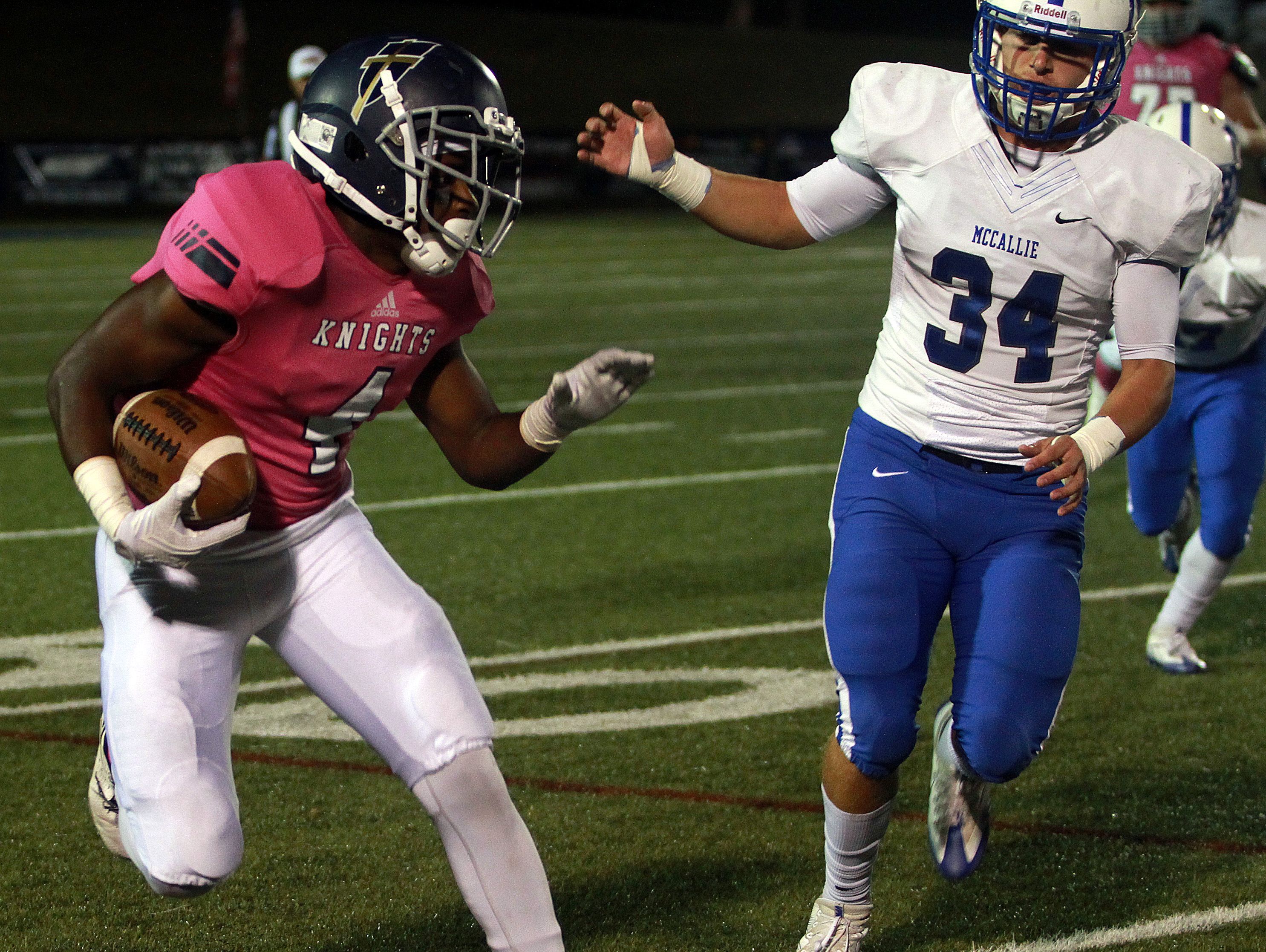 Pope John Paul II's Jamaal Thompson rushes as McCallie's Andrew Presley pursues during a contest earlier this season.