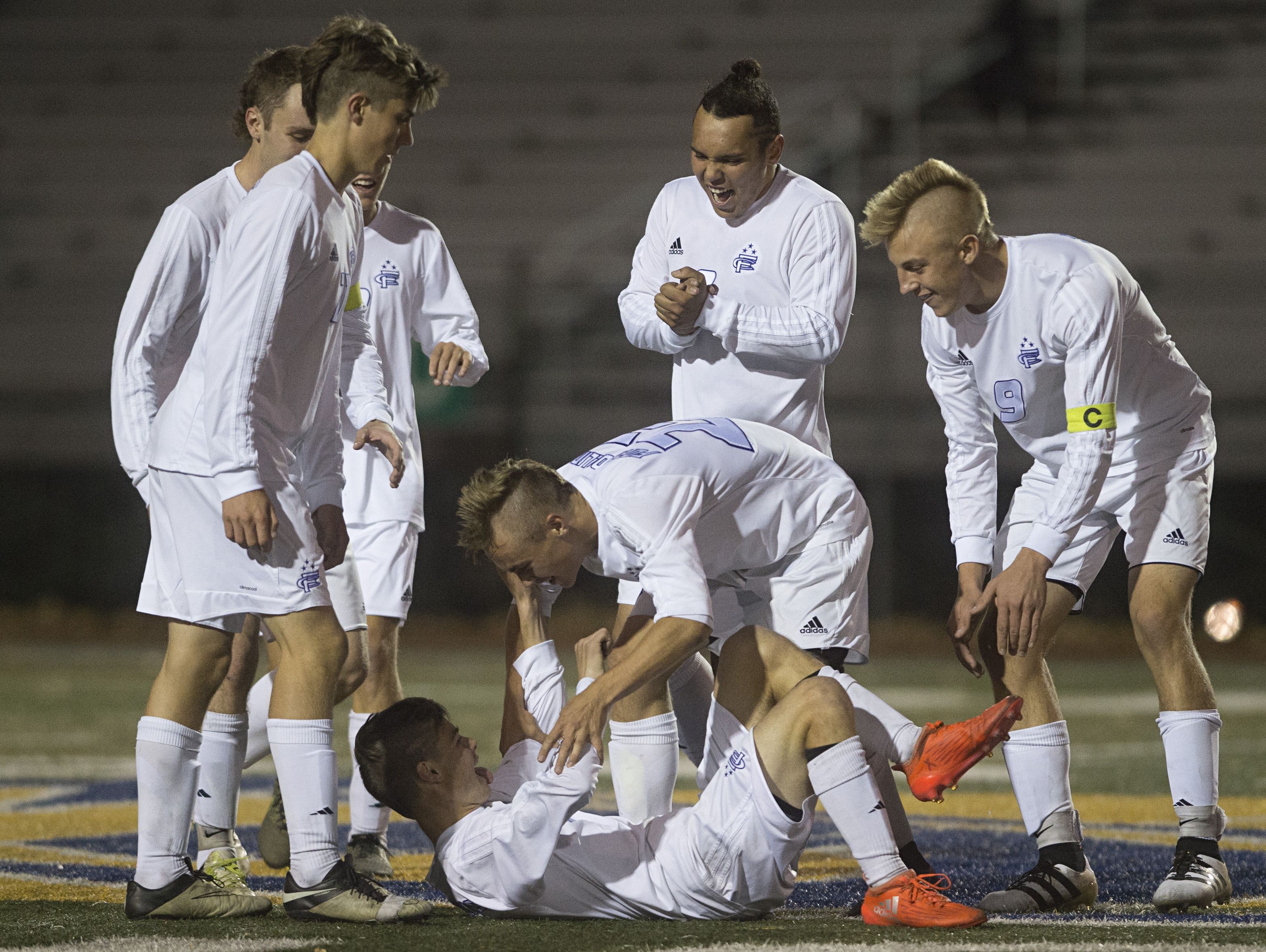 Fort Collins High School celebrates a goal from Logan Katzman during a game against Pine Creek at French Field Wednesday. The Lambkins would go on to win 2-1 and advance to quarterfinals.