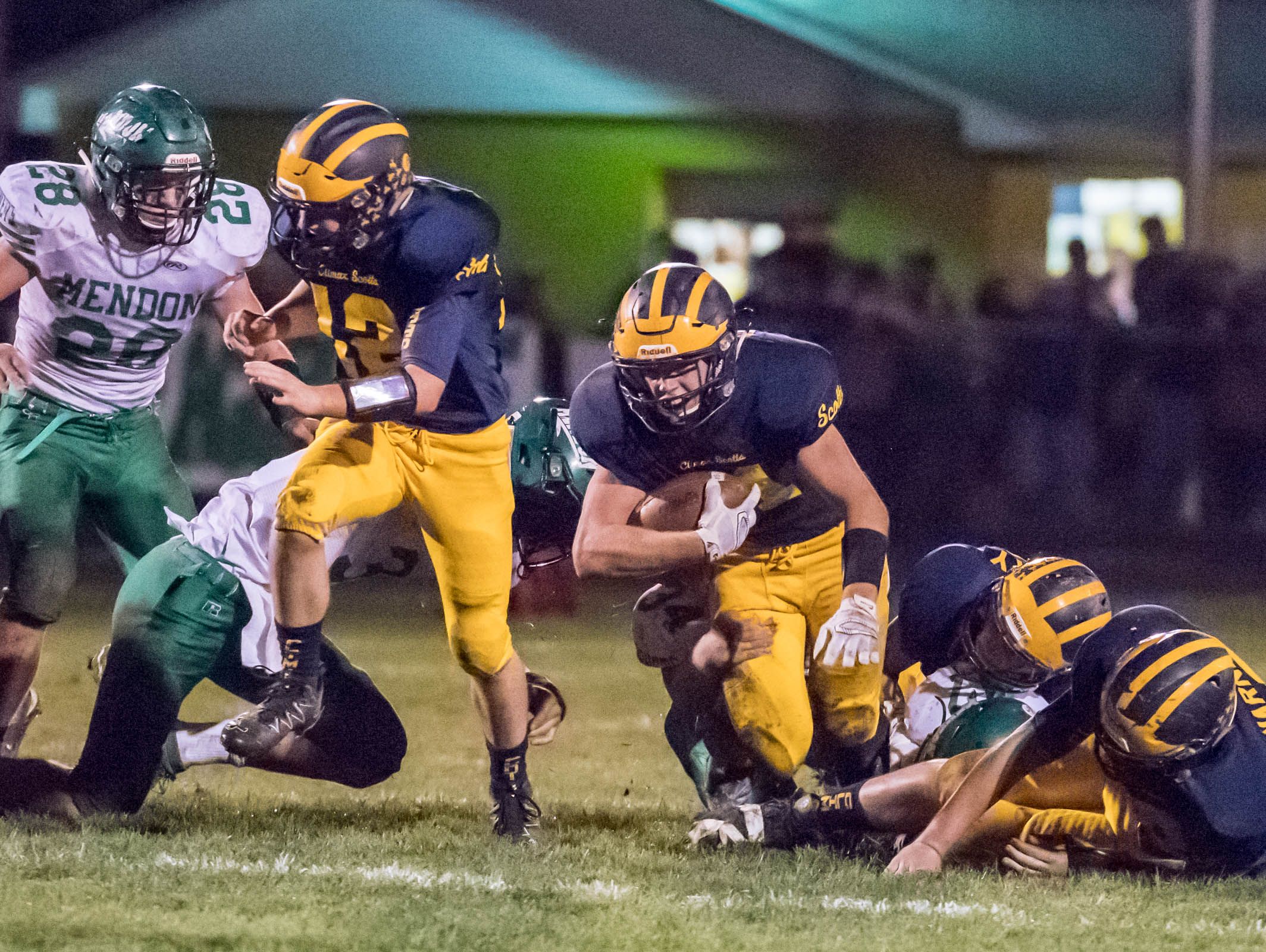 Climax-Scotts's Adam Schantz (20) grinds out for more yardage during first half action against Mendon in the second round of the playoffs