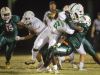 Fort Myers High School’s Darrian Felix is tackled for a loss against Dunbar during first quarter play Friday at Dunbar High School in Fort Myers. Dunbar beat Fort Myers 29-21.
