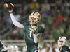 Dunbar High School’s Jairus Johnson completes a first down pass against Fort Myers during first quarter play Friday at Dunbar High School in Fort Myers. Dunbar beat Fort Myers 29-21.