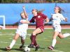 Arlington's Molly Feighan, center, tries to keep the ball away from Monroe-Woodbury's Kayla MacKenzie, left, during Saturday's Class AA regional final.