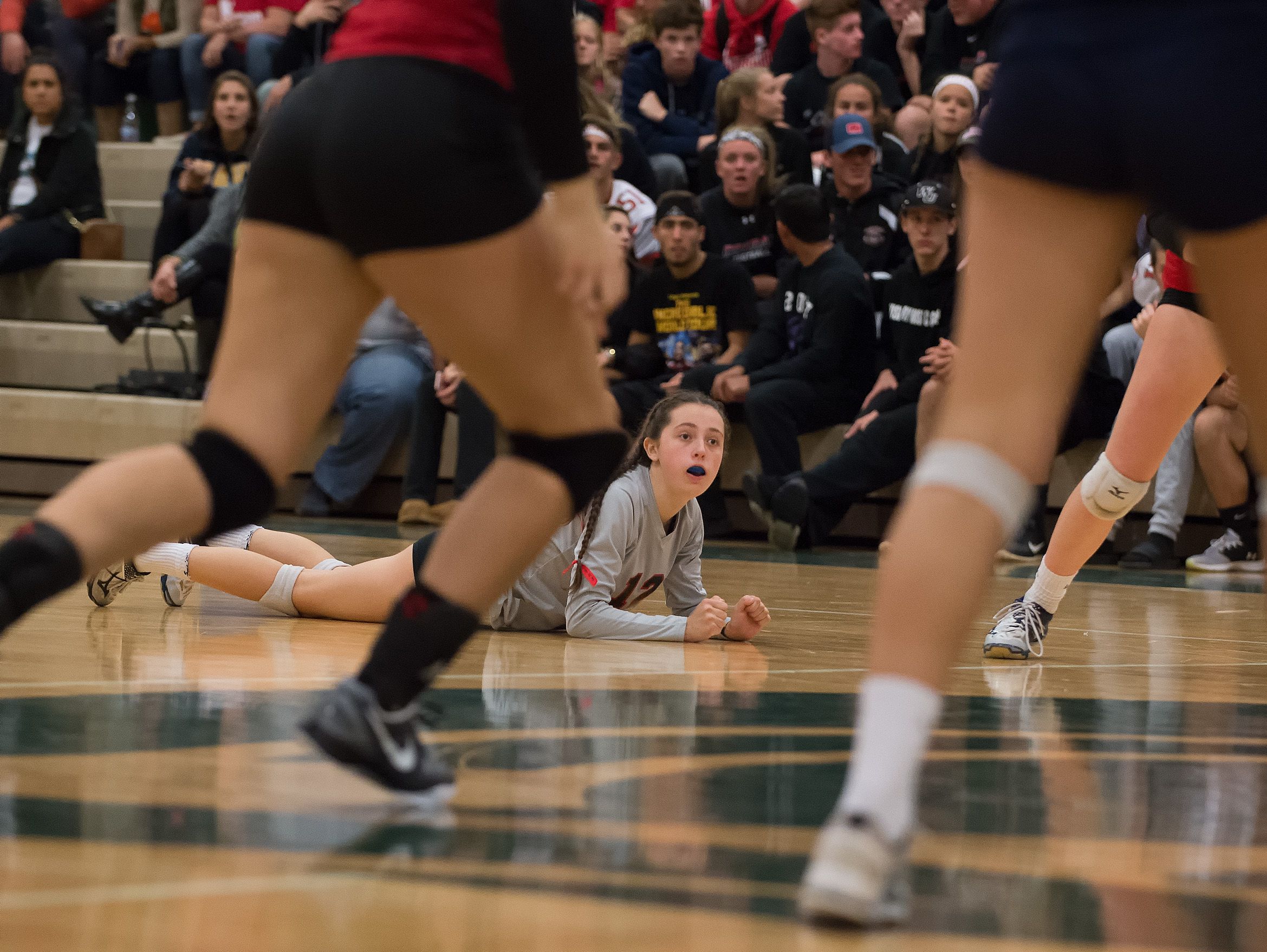 Conrad's Alyssa Faville (12) watches the ball head to the net and diving to save it in the second round game of the DIAA State Volleyball Tournament against Delaware Military Academy.