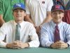 Athletes Matthew Estrada (University of West Florida), left, and Carl Gindl (University of Mississippi) sport hats after signing letters of intent to play baseball for their respective colleges during a press conference at Catholic High School in Pensacola on Wednesday, November 9, 2016.