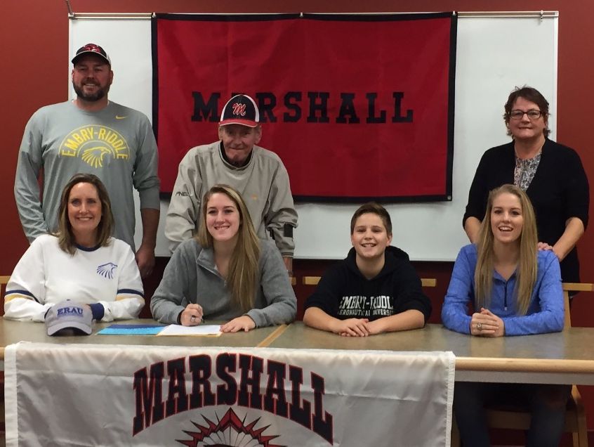Marshall senior Nikki Tucker (center) is surrounded by family as she signed a National Letter of Intent on Thursday to play basketball at Division II Embry–Riddle Aeronautical University. Standing (L-R) are Brent Tucker, Gene Tucker and Carol Tucker; seated (L-R) are Jackie Tucker, Nikki Tucker, Nate Tucker and Natalie Tucker.