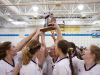 The Bronson High School volleyball team holds up their regional trophy after beating Kalamazoo Christian Thursday evening