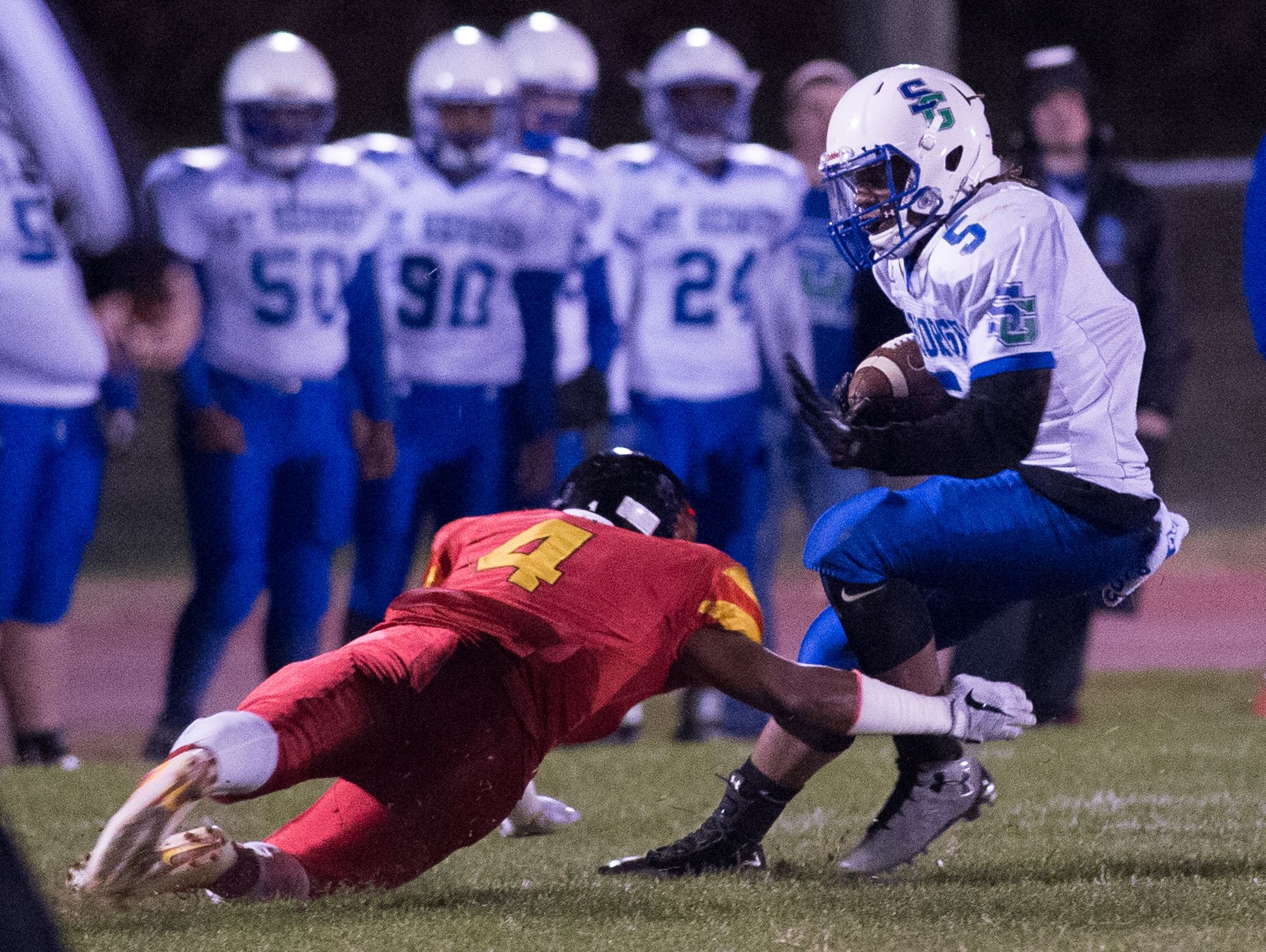 St. Georges' Brian Benson (5) is tackled by Glasgow's Reginald Grinnell (4) in the first quarter at their game at Glasgow High School.