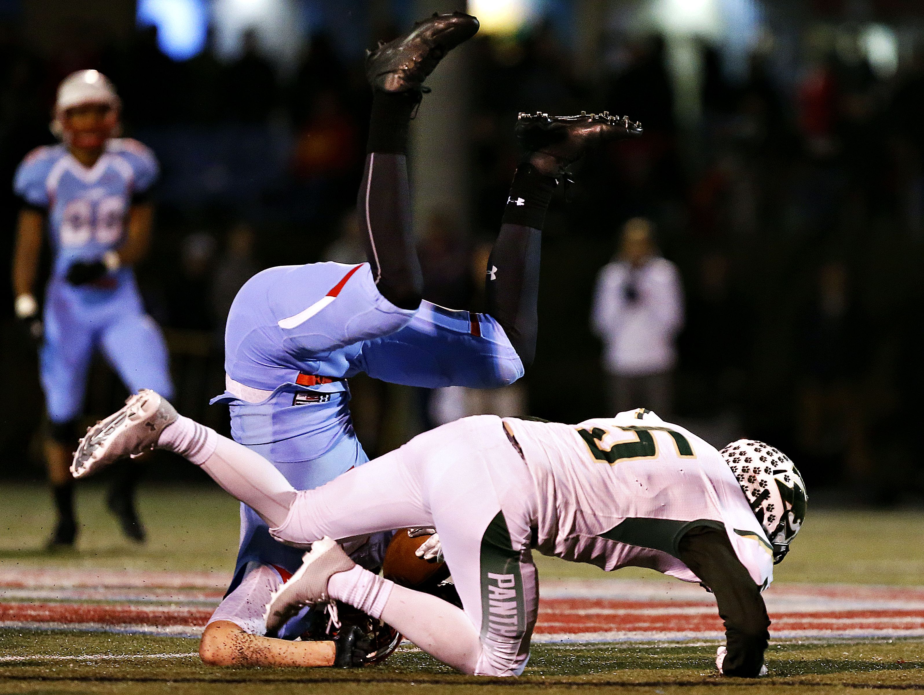 Glendale High School wide receiver Spencer Wester (2) is upended by Panthers defensive backs Jack Ederer (5) and Jacob Triplett (21) during second quarter action of the playoff game between Glendale High School and Ft. Zumwalt North High School held at Lowe Stadium in Springfield, Mo. on Nov. 11, 2016.