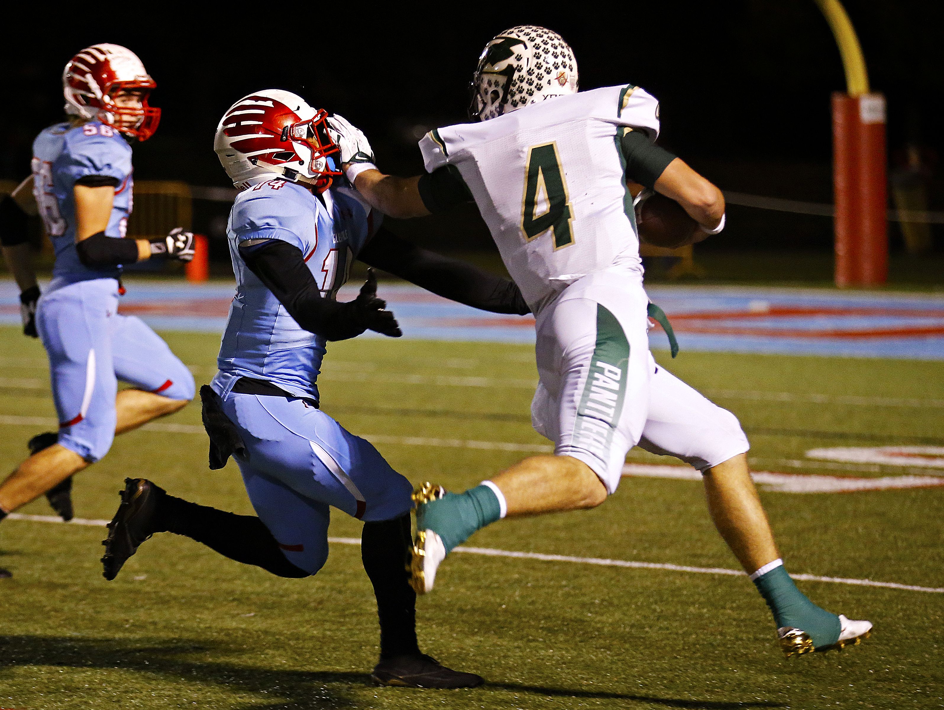 Ft. Zumwalt North High School quarterback Cade Brister (4) stiff arms Falcons defensive back Myles Sith (14) during first quarter action of the playoff game between Glendale High School and Ft. Zumwalt North High School held at Lowe Stadium in Springfield, Mo. on Nov. 11, 2016.