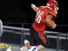 Riverheads' Dalton Jordan tries to leap over Essex's Isaiah Taylor who wraps him up around the legs and brings him down during a Region 1A East semi-final football game played in Greenville on Friday, Nov. 18, 2016.