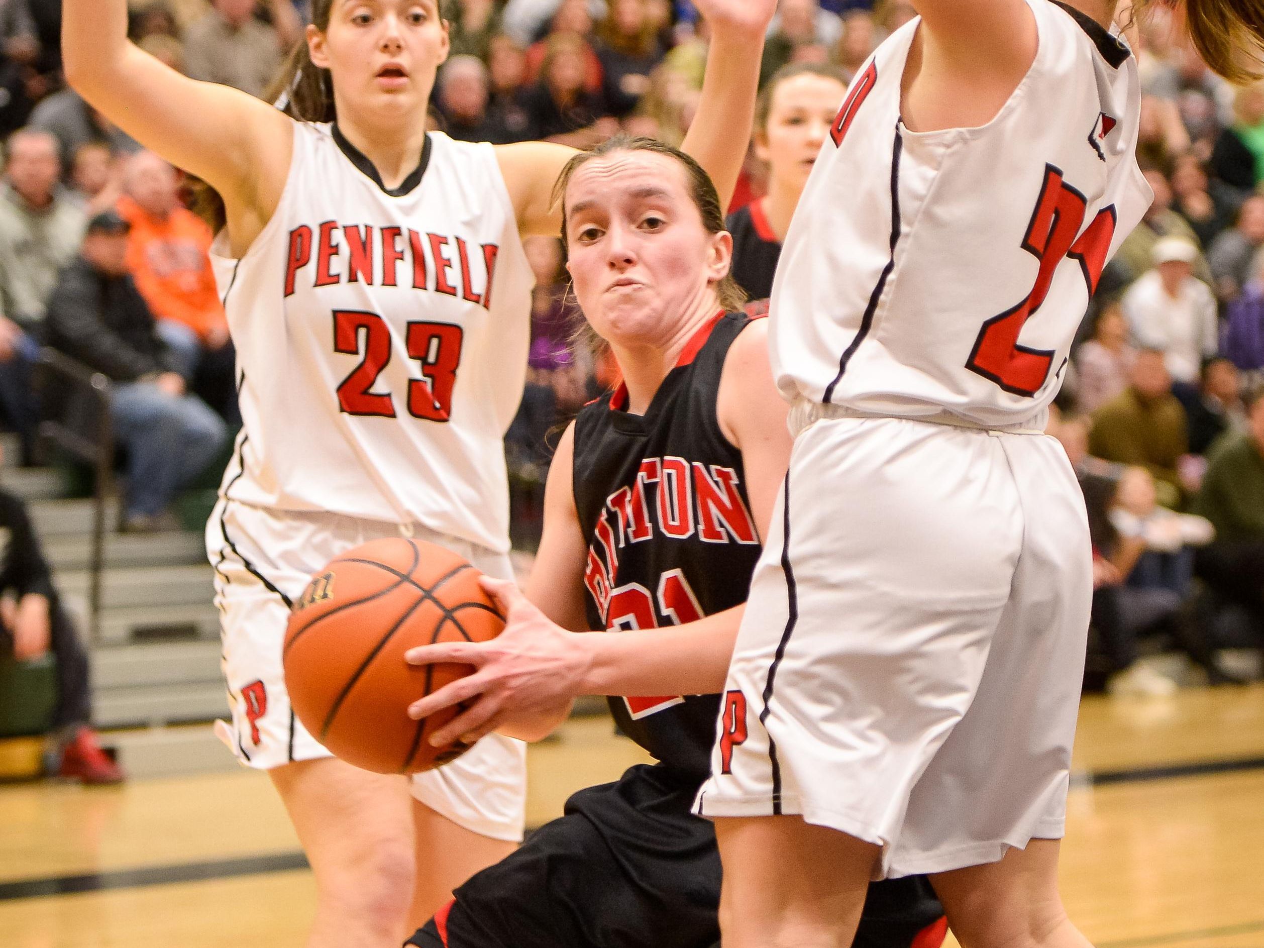 Hilton's Alyssa Juergens rebounds the ball defended by Penfield's Gabby Pancio (21) and Olivia Colombo (23) in the first half of Saturday's Class AA girls basketball championship.