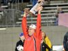 Powers North Central coach Kevin Bellefeuil holds up the 8-man state championship trophy.