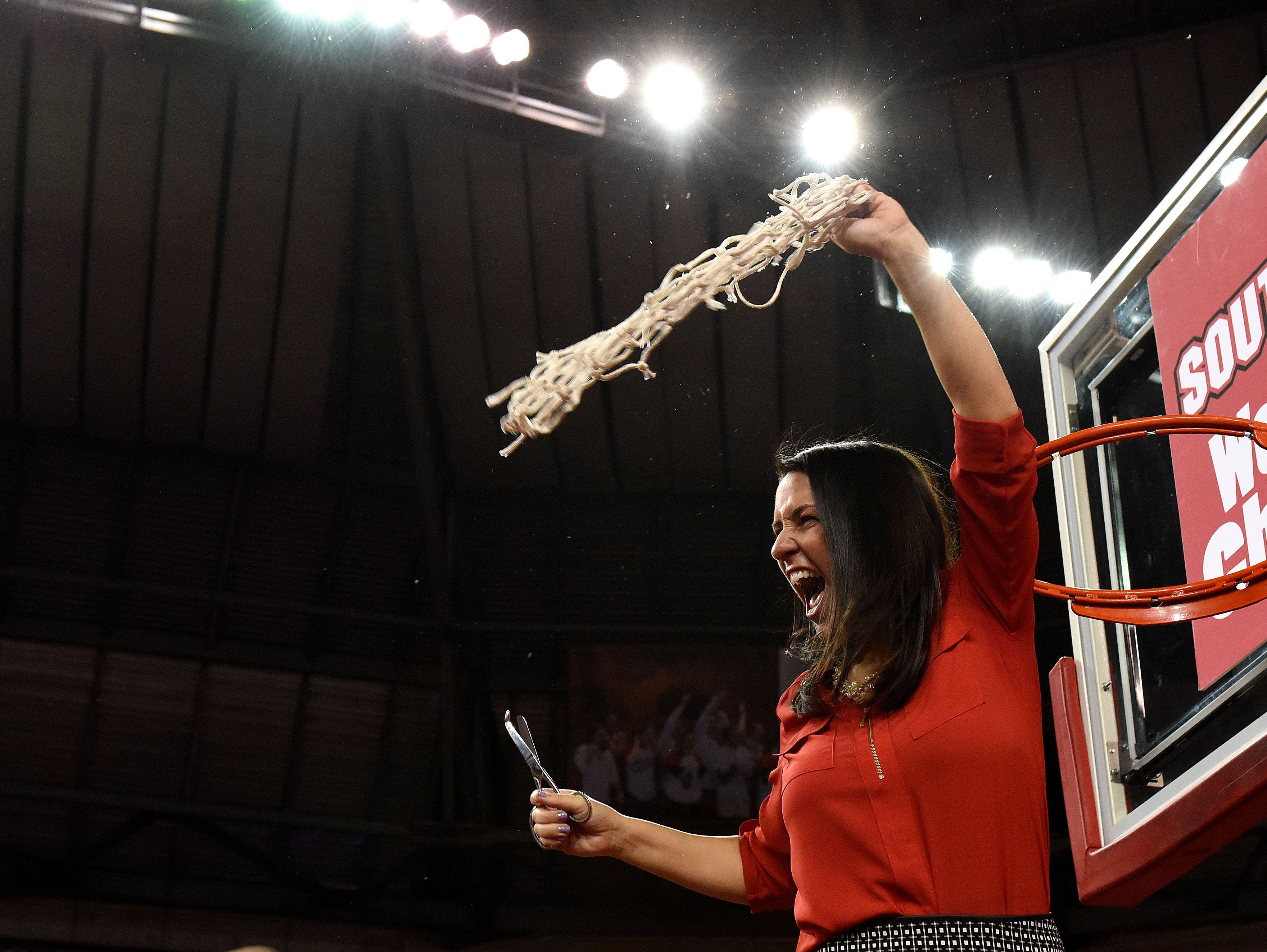 USD's Amy Williams celebrates after her team wins the WNIT championship over FGCU at the DakotaDome in Vermillion, S.D., Saturday, April 2, 2016.