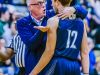 East Lansing boys basketball head coach Steve Finamore, left, speaks with DeAndre' Robinson during a game with Holt last season.