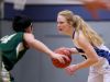 Western Mennonite's Madison Hull (13) moves past Regis' Ashtyn Chamberland (14) in the Regis vs. Western Mennonite girl's basketball game at Western Mennonite High School on Wednesday, Feb. 17, 2016.