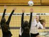 Silverton High School's Maggie Buchholz (8) goes up for a kill but is blocked by Summit defenders during the 2015 state volleyball tournament.