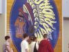 In this 2004 file photo, students pass a section of the old floor from the Whiteland High School gymnasium which has been preserved as a an eye-catching mural just outside the school cafeteria. The Indian head reflects the school nickname "Warriors".