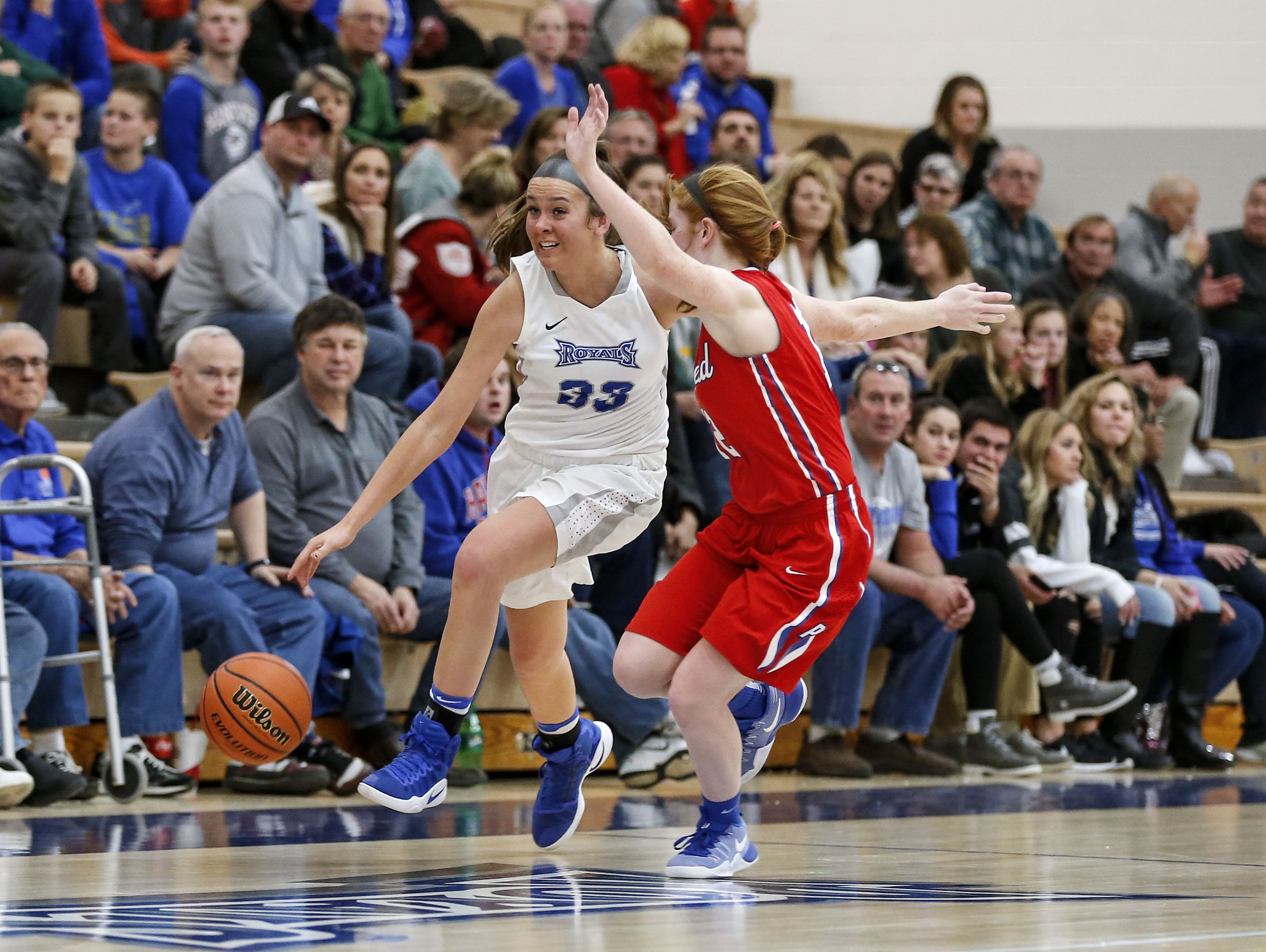 Hamilton Southeastern's Sydney Parrish (33) tries to get past Plainfield’s Samantha Olinger during Thursday's girls basketball game.