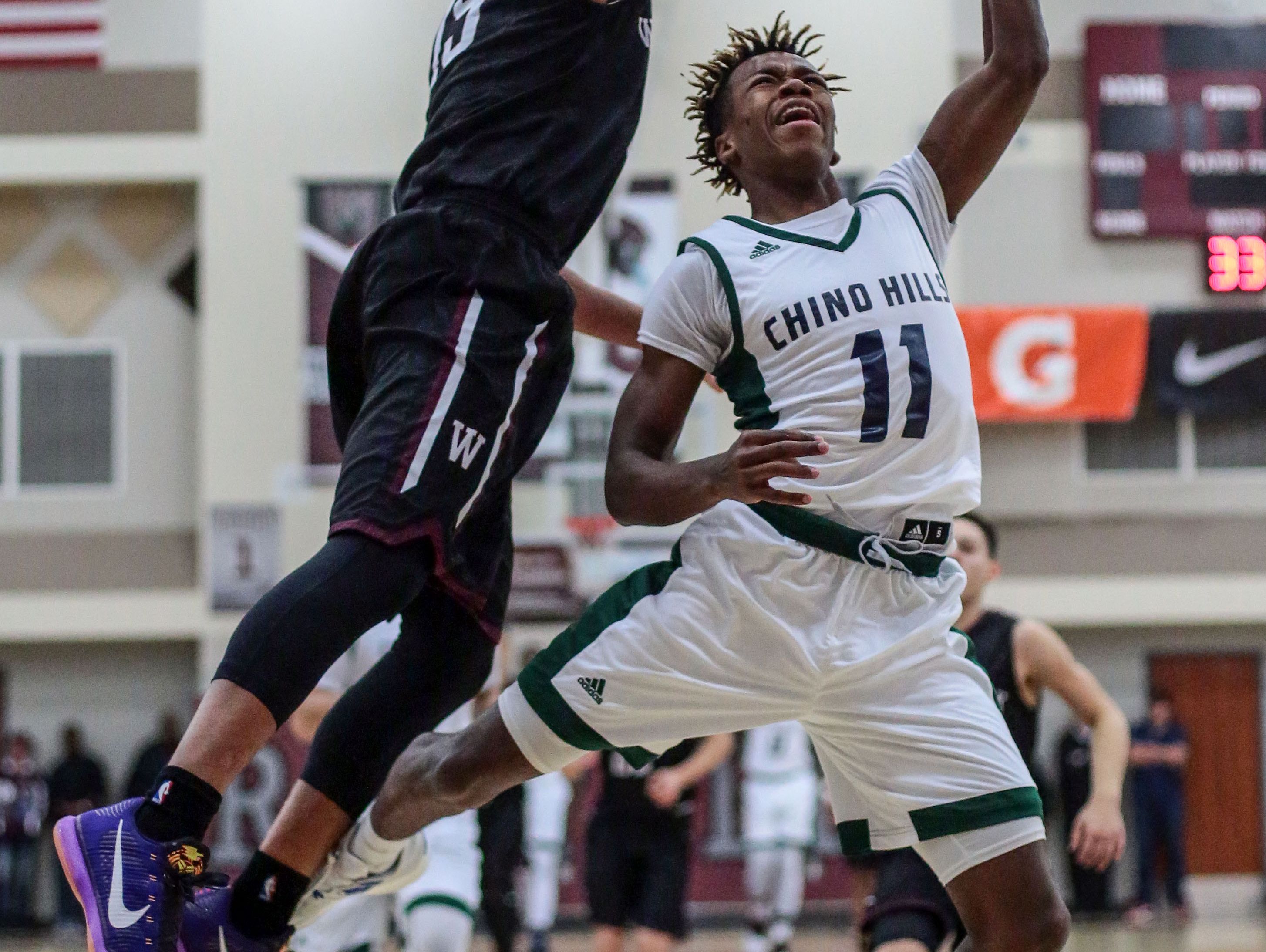 Chino Hills' Phaquan Davis is blocked by Woodcreek's Jackson Hughes as he tries to shoot on Wednesday, December 28, 2016 during the Rancho Mirage Holiday Invitational at Rancho Mirage High School.