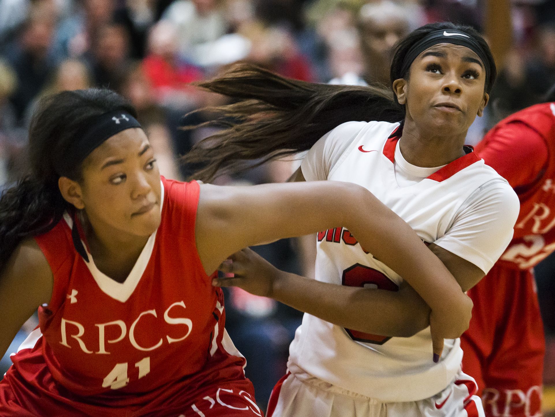 Ursuline's Yanni Hendley-Mccalla fights for rebound position with Roland Park's Christyn Robinson (left) in the second half of Ursuline Academy's 47-40 win over Roland Park Country School in the Diamond State Classic at St. Elizabeth High School in Wilmington on Friday evening.