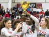 Ursuline's Kryshell Gordy holds the championship trophy as she celebrates with teammates following Ursuline Academy's 47-40 win over Roland Park Country School in the Diamond State Classic at St. Elizabeth High School in Wilmington on Friday evening.