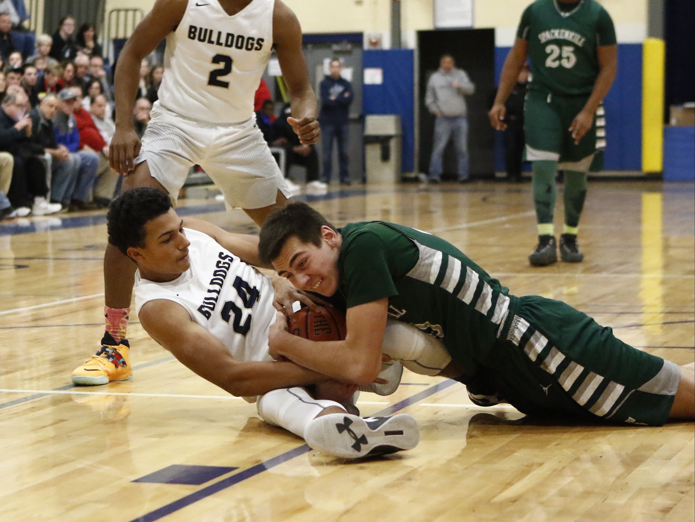 Beacon Dionte Komisar wrestles for a loose ball with Spackenkill's John Timm during the Duane Davis Memorial Tournament.