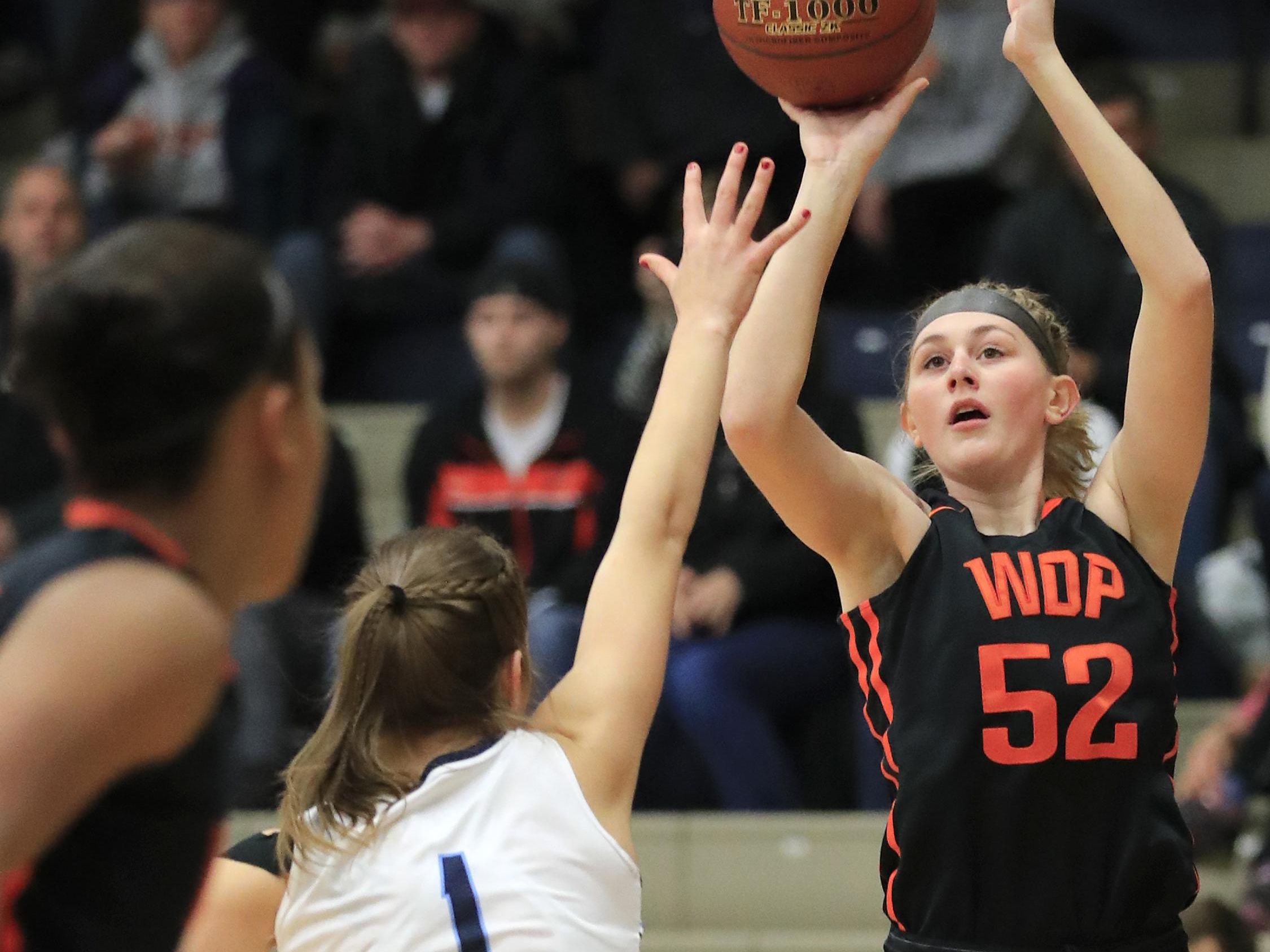 West De Pere's Hannah Stefaniak (52) shoots over Bay Port's Maddie Re (1) at Bay Port High School on Friday during a nonconference girls basketball game. The Phantoms won 46-39 in a matchup between conference leaders.