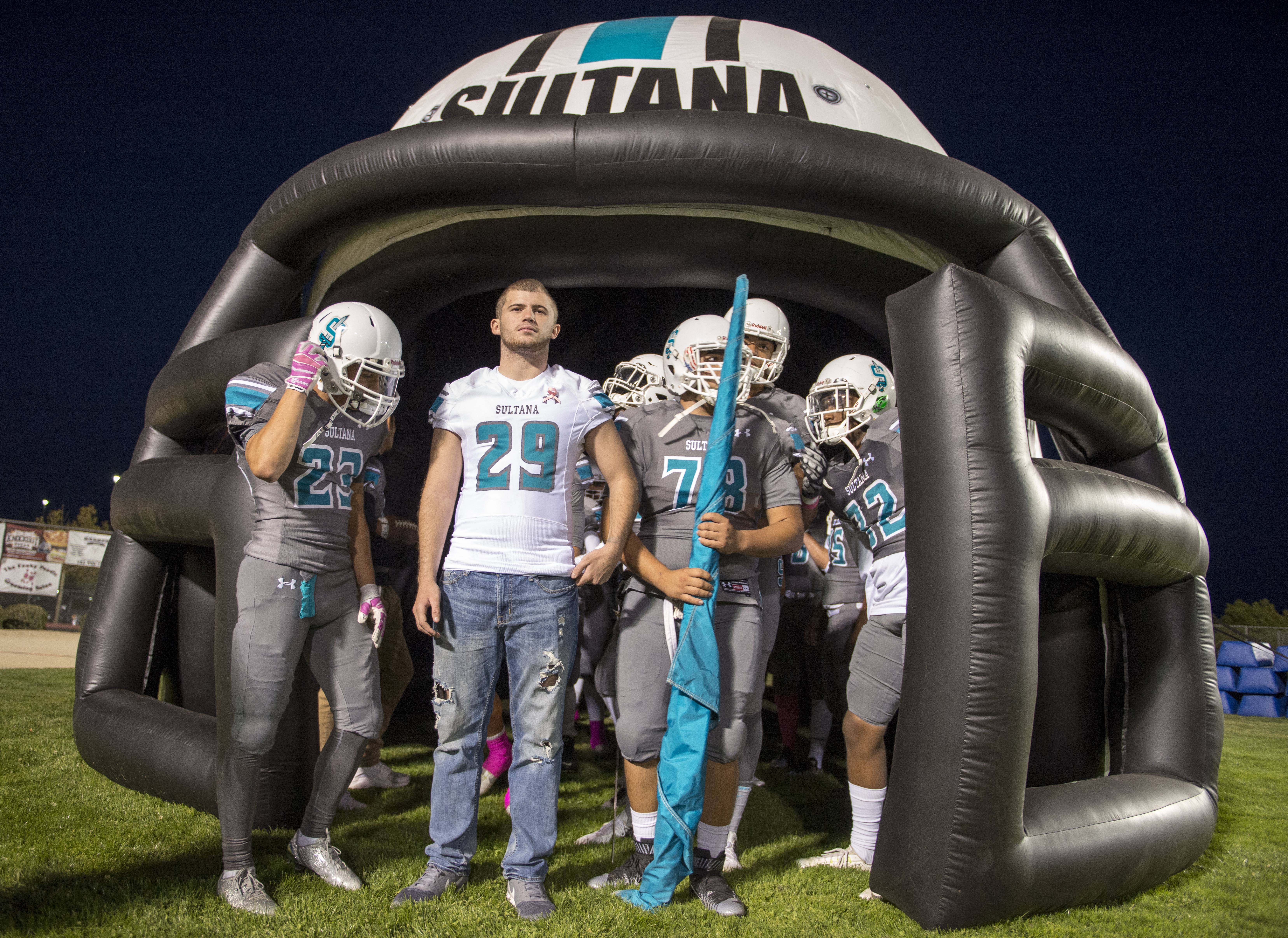 Bruce Henderson, wearing number 29 prepares to lead the Sultana Sultans onto the field. Henderson made his first appearance at a school football game on Friday October 7, 2016 after suffering a major head injury. (James Quigg, Daily Press) [Via MerlinFTP Drop]