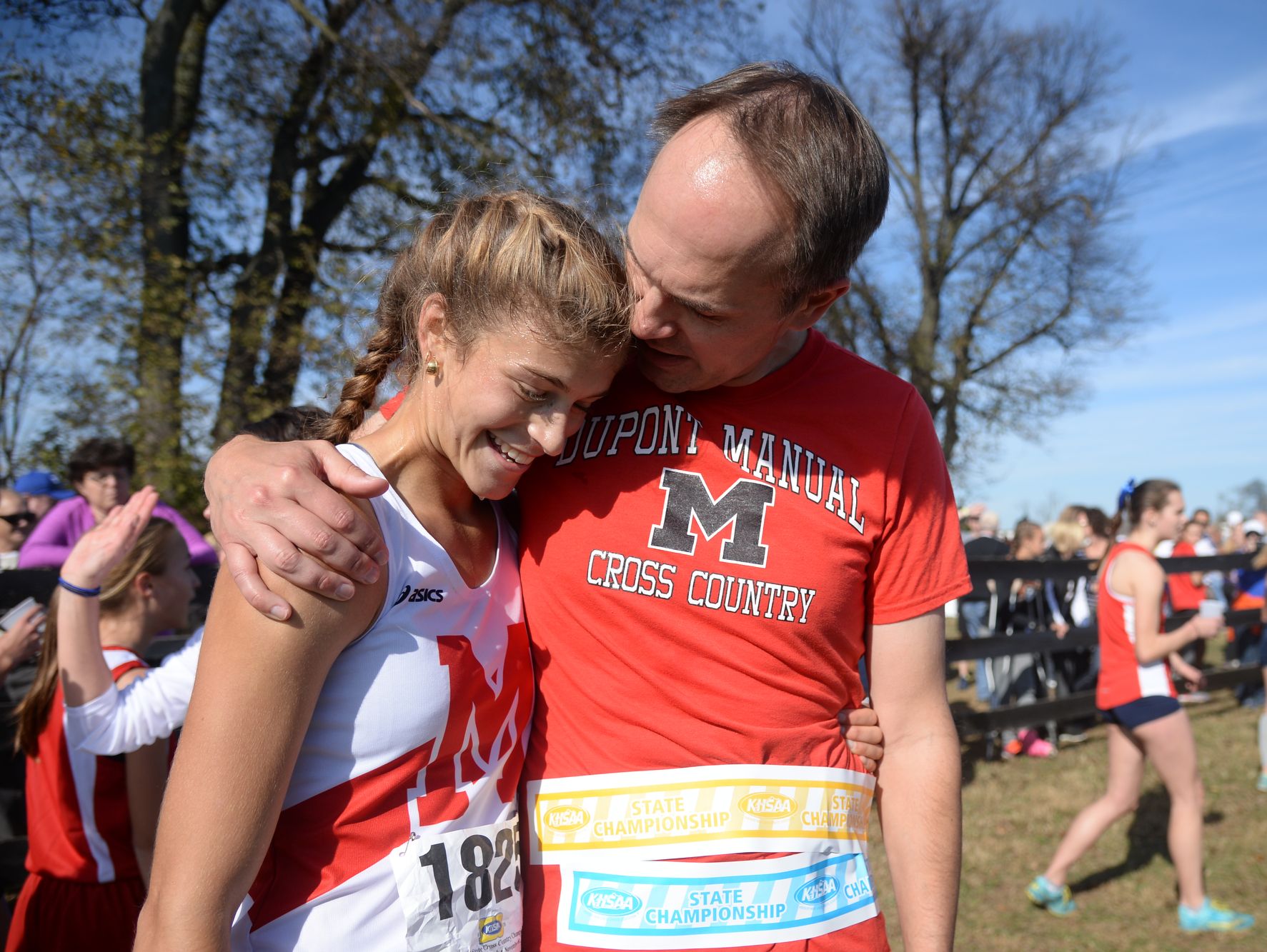 Dupont Manaul's Alena Sapienza-Wright hugs her coach, Tim Holman, after winning the KHSAA Class 3-A girls state cross country meet at the Kentucky Horse Park in Lexington, KY on Saturday, November 5, 2016.