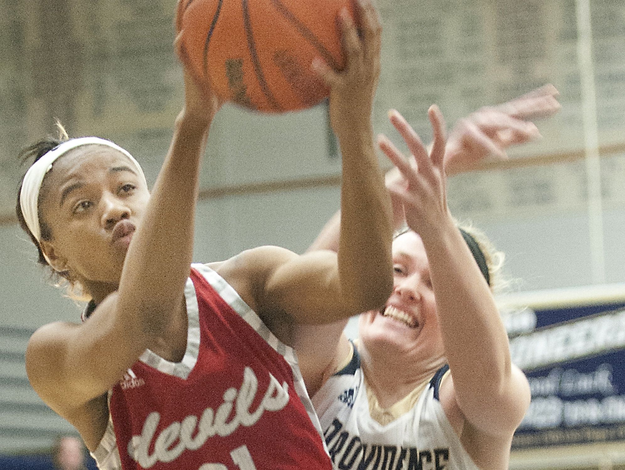 Jeffersonville guard Jhala Henry puts up a shot as Providence forward Claire Rauck defends the basket. 03 January 2017