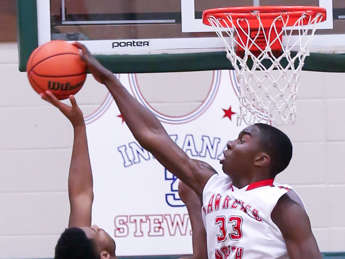 Lawrence North's Ra Kpedi (33) blocks the shot of Cathedral's Austin Kendrick in the Wildcats' win Wednesday.