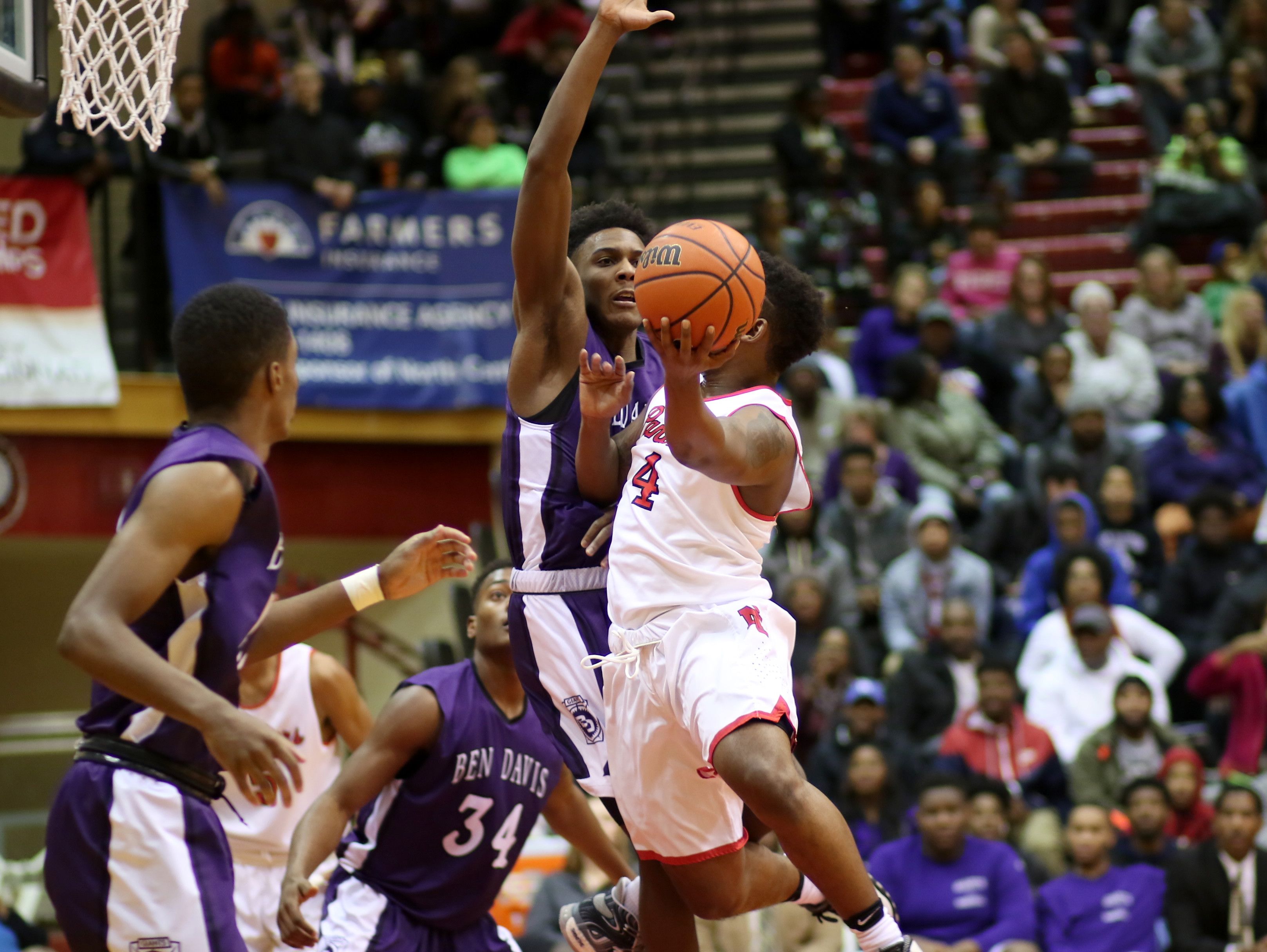 North Central's Emmanuel Little rises up against a Ben Davis' Trevaughn Bush during Friday night's game in Indianapolis.