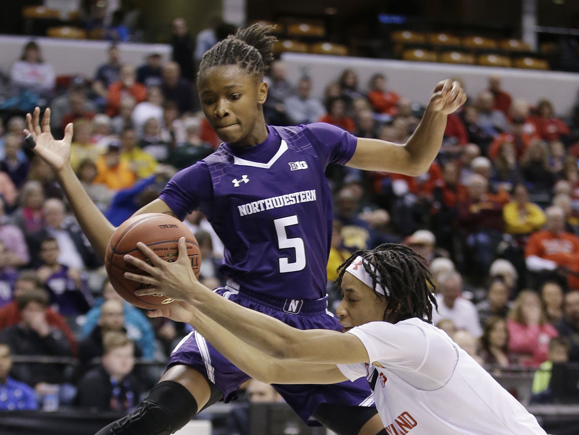In this March 5, 2016, file photo, Maryland's Brene Moseley (3) and Northwestern's Jordan Hankins (5) go for a loose ball during an NCAA college basketball game at the Big Ten Conference tournament in Indianapolis. Hankins has been found dead in her room at the university.