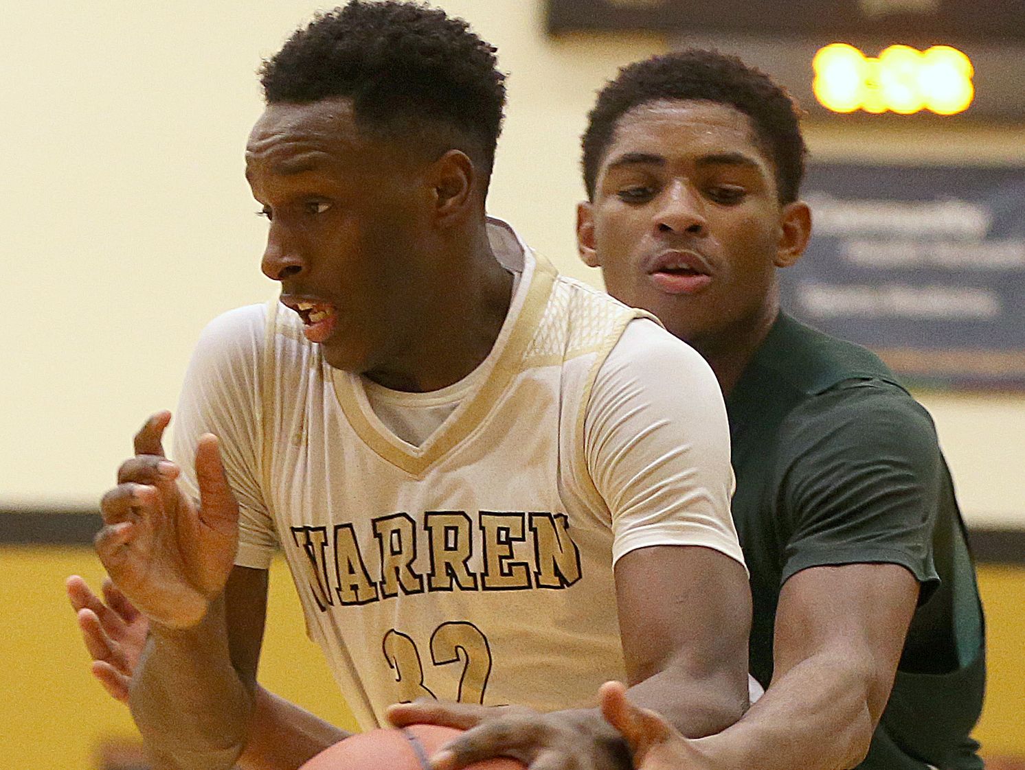 Lawrence North Wildcats forward Kevin Easley Jr. (34) fouls Warren Central Warriors forward Mack Smith (32) during second half action of Marion County boys quarterfinals between Warren Central and Lawrence North, at Warren Central High School, Indianapolis, Wednesday, Jan. 11, 2016. Warren Central defeated Lawrence North, 52-43.