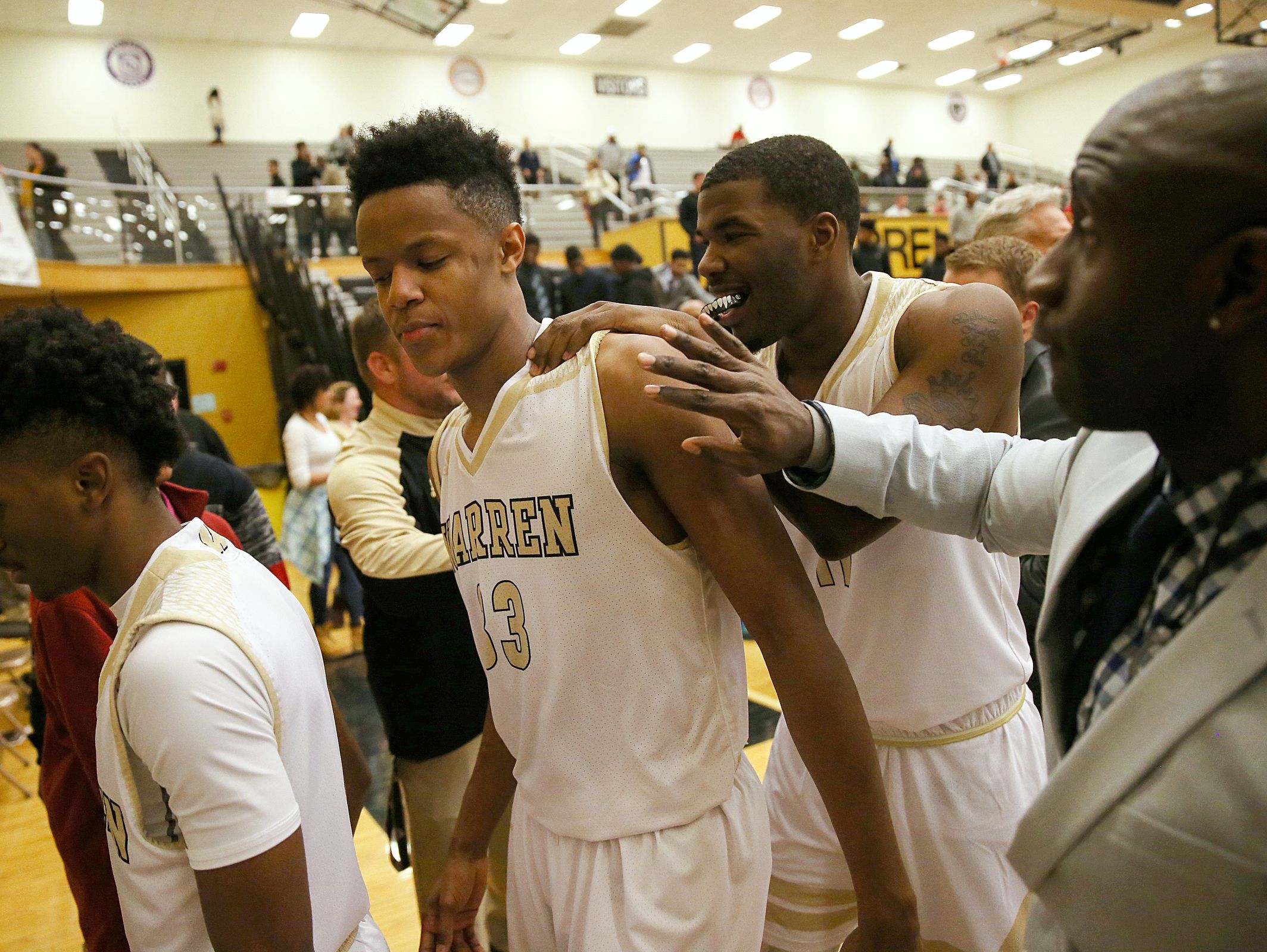 Warren Central Warrior Ki-ng Tyler (33) is congratulated after Warren Central won Marion County boys quarterfinals at Warren Central High School, Indianapolis, Wednesday, Jan. 11, 2016. Warren Central defeated Lawrence North, 52-43.