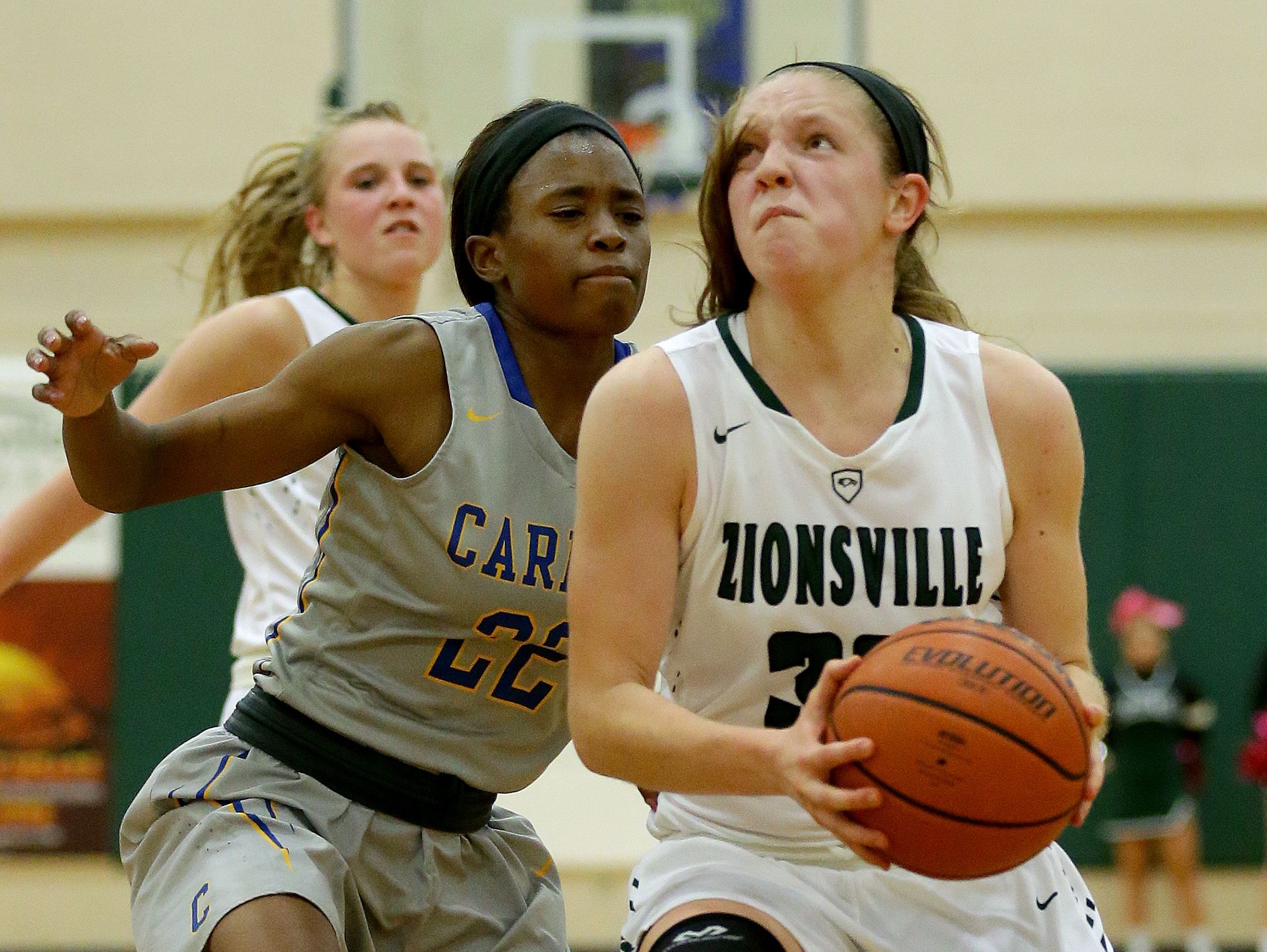 FILE -- Zionsville Eagles Rachel McLimore (32) drives to the basket around Carmel Greyhounds Tomi Taiwo (22) in the first half of their game Tuesday, November 15, 2016, evening at Zionsville High School.