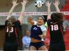 Cathedral's Nia Robinson spikes the ball through Center Grove's Malea Howie, left, and Tonia Rumble during their match held at Center Grove High School on Tuesday, August 25, 2015. Cathedral pulled off the win in the 5th set.
