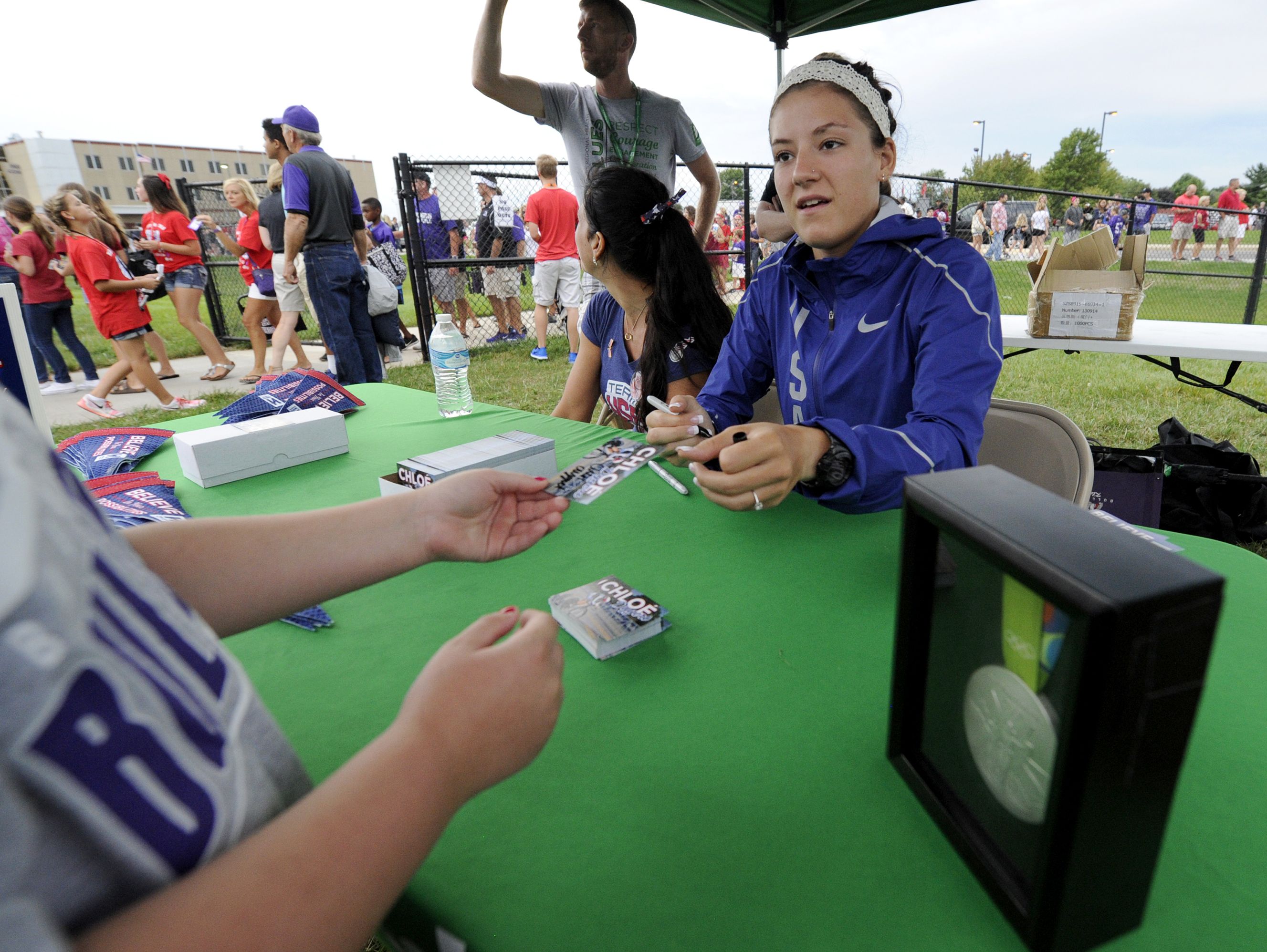 Olympic silver medalist Chloe Dygert signs autographs before a Brownsburg football game Aug. 26.