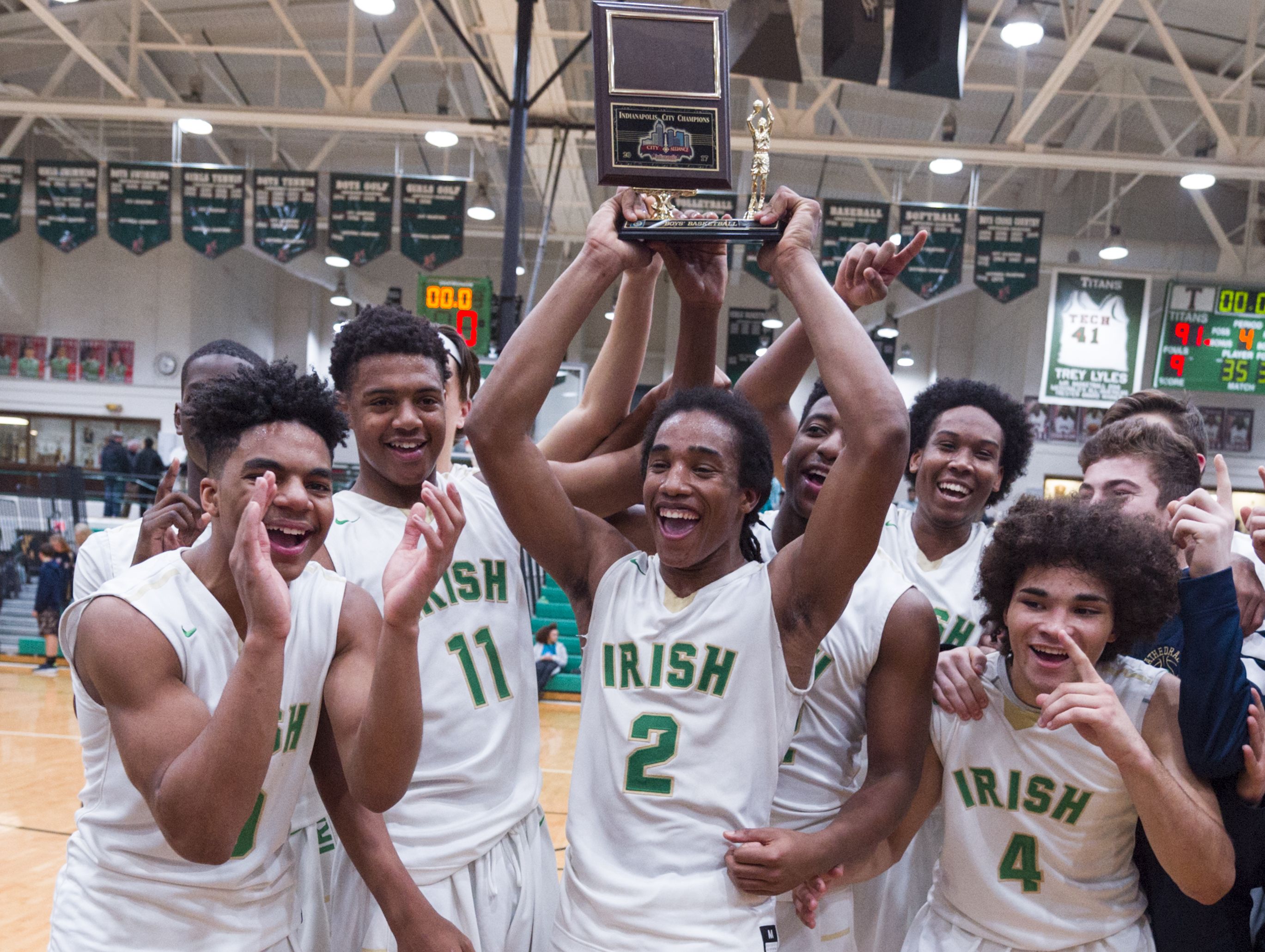 The Cathedral High School team celebrate their victory in the Indianapolis City Boy's Basketball Tournament championship game Monday, Jan. 23, 2017, at Arsenal Tech High School. Cathedral won 91-67.