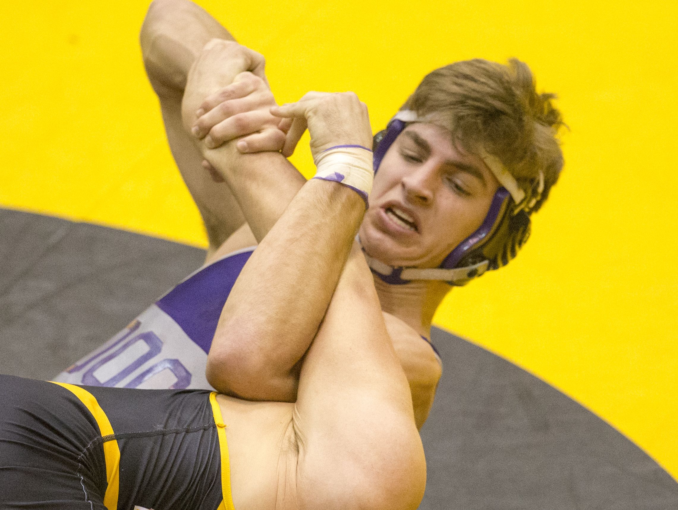 Nathan Walton (top), of Brownsburg, cranks on the arm of Avon's Caden Hubner during their 182 pound contest, won by Walton, IHSAA Avon Wrestling Sectional, Saturday.