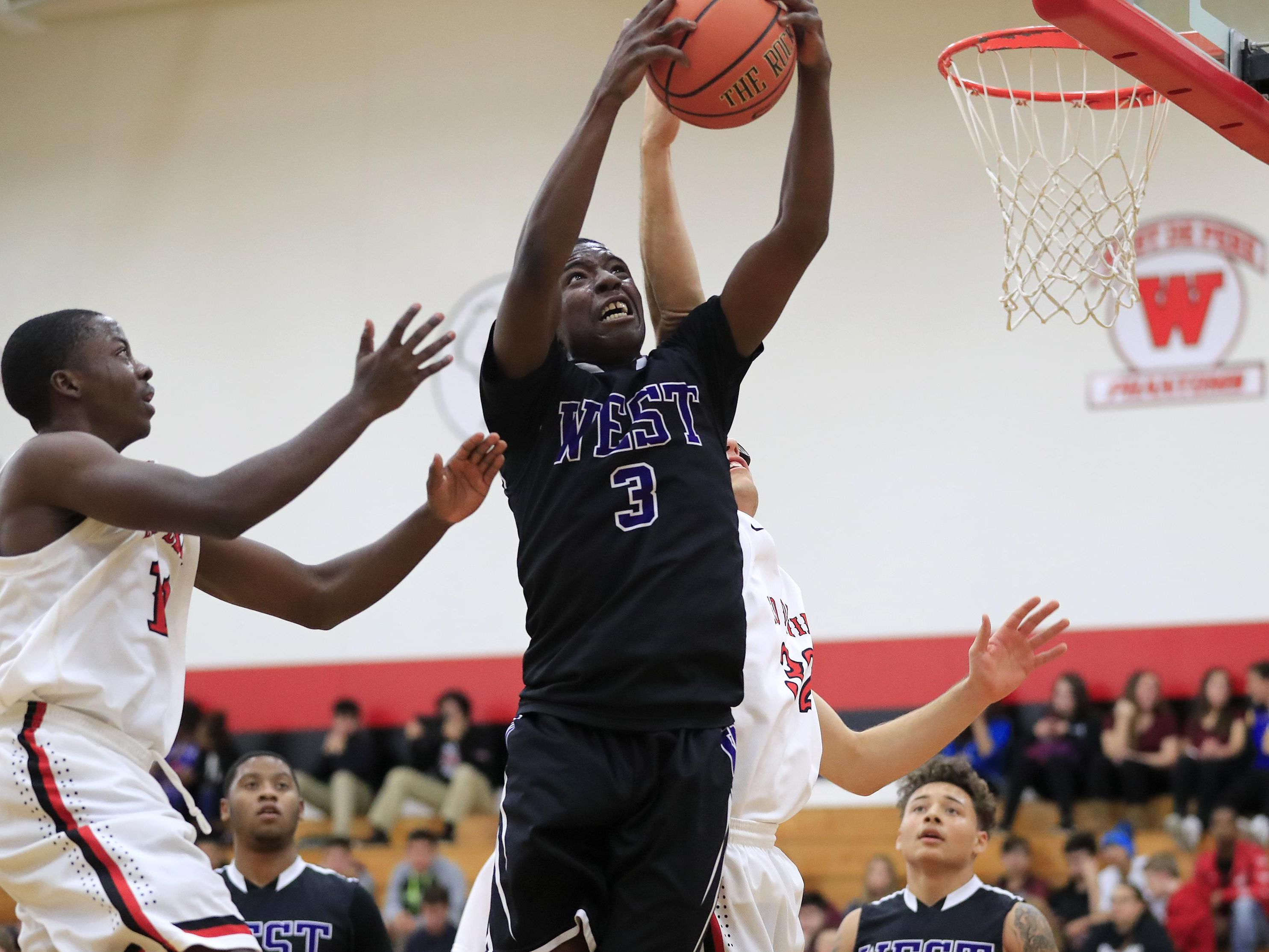 Green Bay West’s JQuail Hanks (3) skies high for a rebound against Green Bay East on Tuesday.