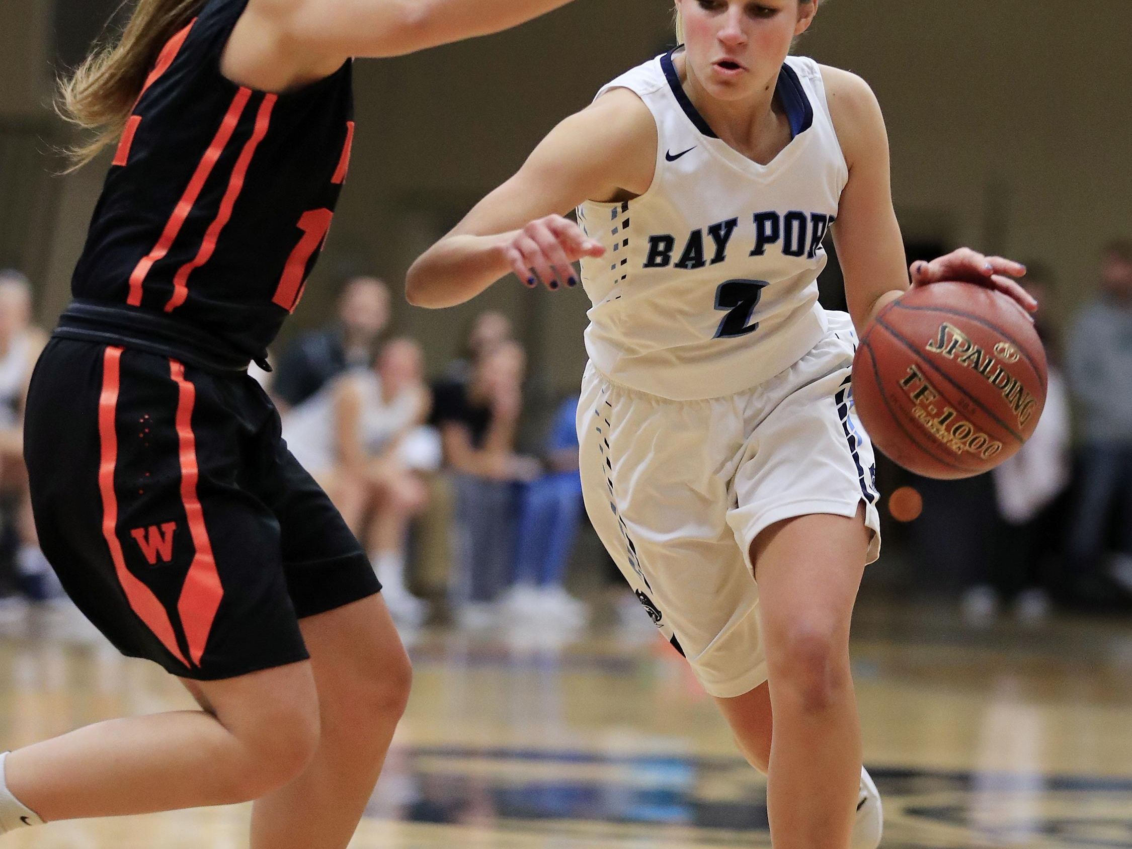 Bay Port's Grace Krause (2) drives against West De Pere's Liz Edinger (12) at Bay Port High School on Friday in a nonconference girls basketball. Bay Port is tied with De Pere atop the Fox River Classic Conference standings.
