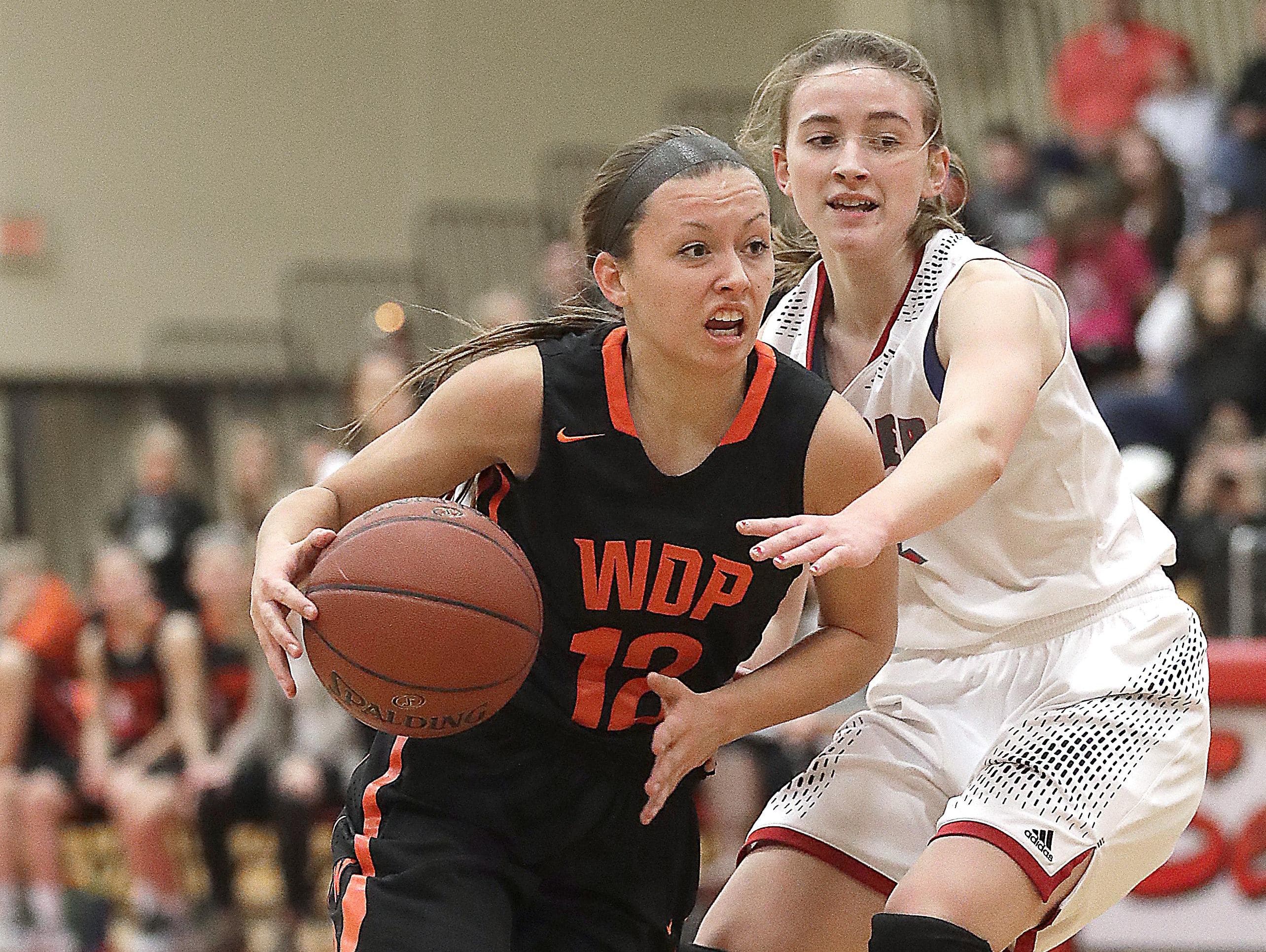 West De Pere senior Liz Edinger drives to the basket to score her 1,000th career point on Thursday at Seymour in a Bay Conference girls basketball game.